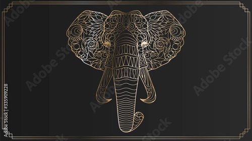 Golden lace head of an elephant on a black background in an elegant frame