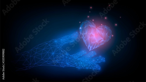 Hologram hand holds a luminous heart, virtual love concept