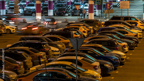 Cars in the Parking lot of a shopping Mall on a night of high sales