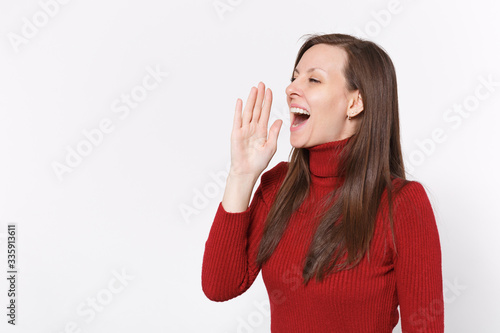 Funny young brunette woman girl in casual red clothes posing isolated on white background studio. People lifestyle concept. Mock up copy space. Screaming with hands gesture near mouth, looking aside.