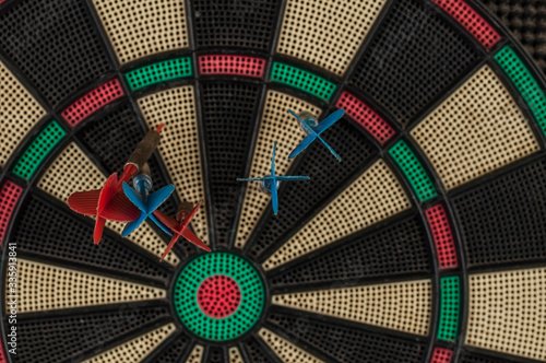 Red and blue dart arrrow hitting in the target.Darts sport concept