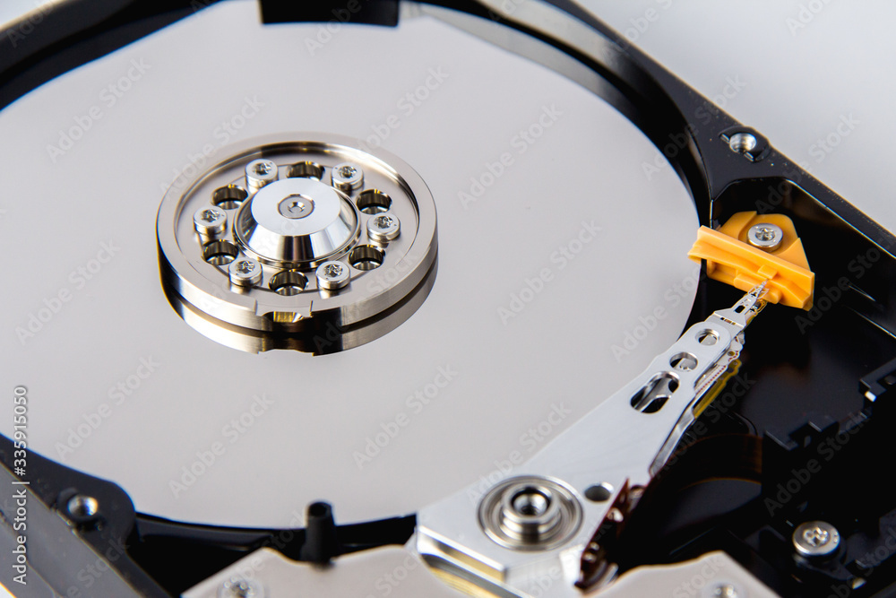 Opened computer hard drive on a white background. Opened computer hard drive on a white background.