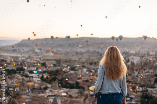 Young woman watching the sunrise in Cappadocia © alikusya