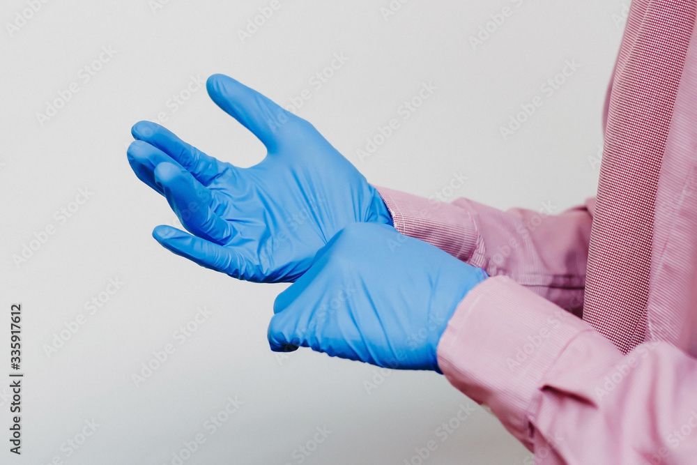 The guy puts on medical gloves The guy puts on medical gloves