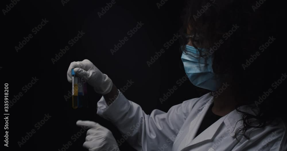 Scientist checks reagents during an experiment. Scientist checks reagents during an experiment.