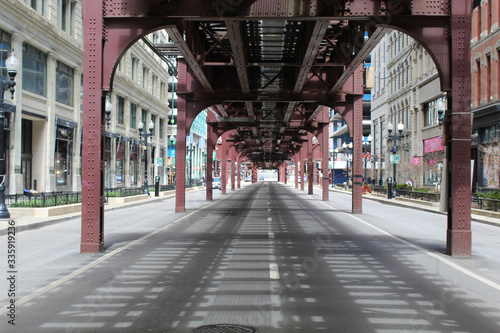 Nearly deserted Wabash Avenue in downtown Chicago under the el train tracks during the COVID-19 shelter-in-place order