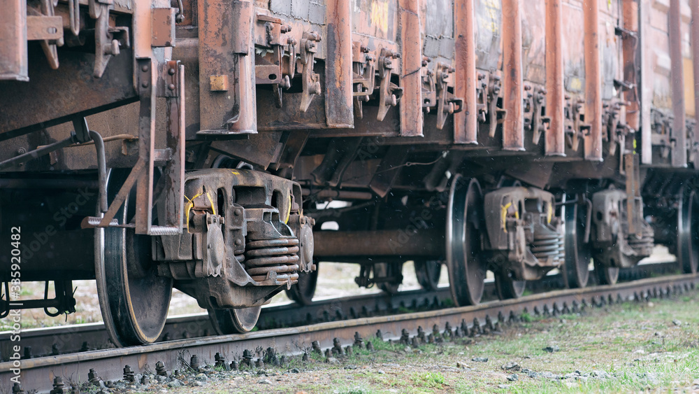 Naklejka premium Old rusty wagons on flights. Side view, selective focus.