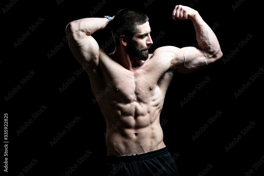 Bodybuilder Showing Biceps on Black Background