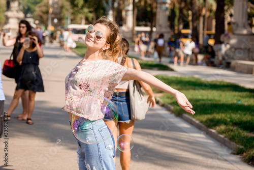 Barcelona, Spain, girl playing and having fun with a soap bubble