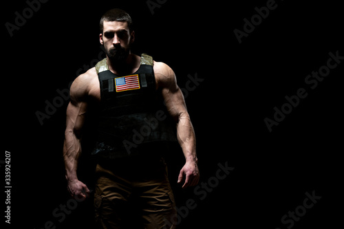 Bodybuilder Soldier With Bulletproof Vest on Black Background