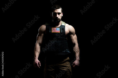 Bodybuilder Soldier With Bulletproof Vest on Black Background