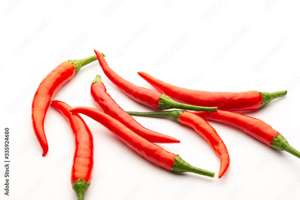 Red chili peppers on a white background. Isolate. Hot peppers. A few fresh pods of red pepper.