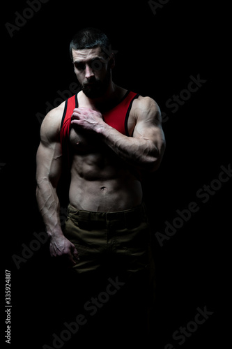 Young Bodybuilder Flexing Muscles Isolate on Black Blackground