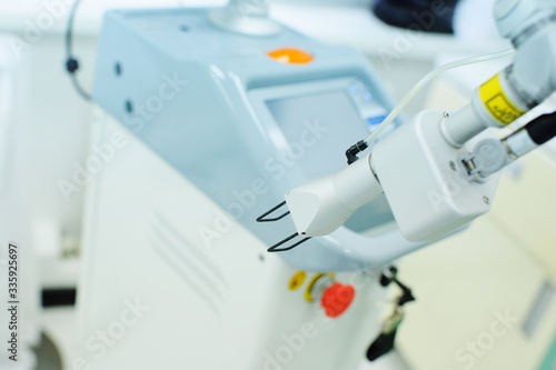 modern device for skin rejuvenation-fractional laser close-up on the background of a cosmetology clinic