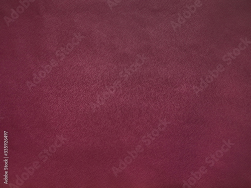 Cherry colored faux leather surface texture, background.