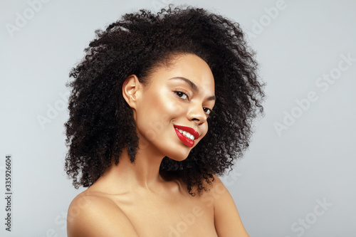 African American Fashion Model portrait. Brunette curly haired young woman. Beauty salon and haircare concept. photo