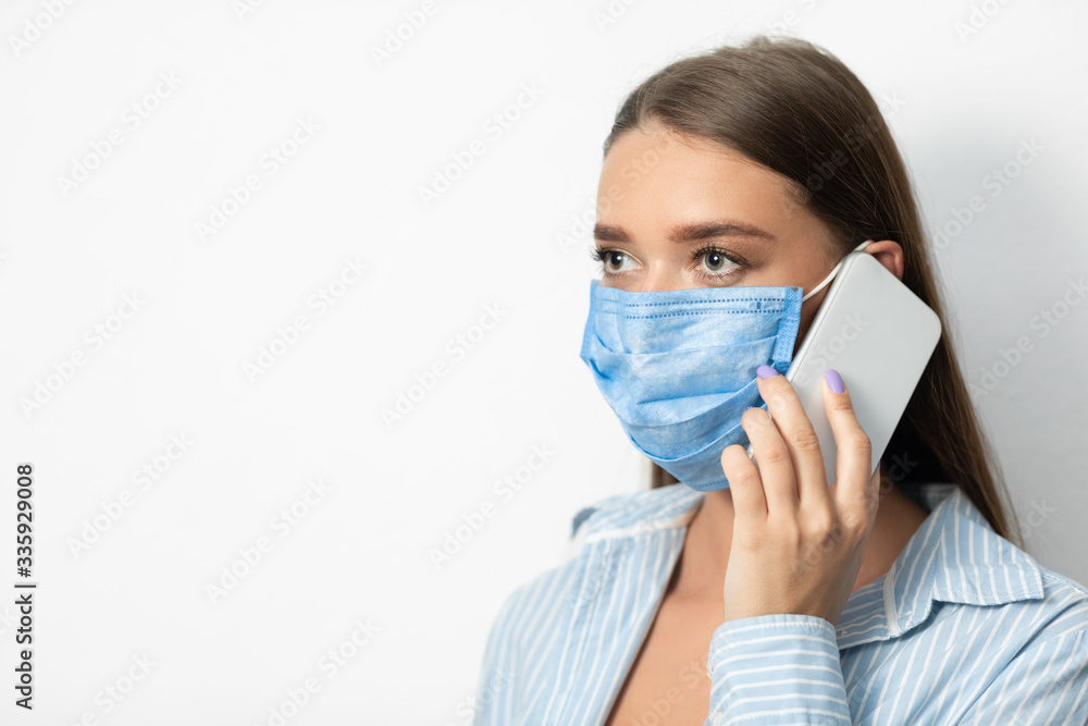 Girl In Medical Mask Talking On Phone Over White Background