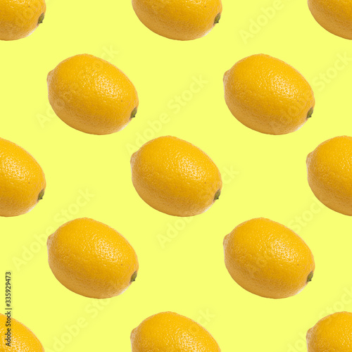 Seamless pattern with yellow lemons on yellow background