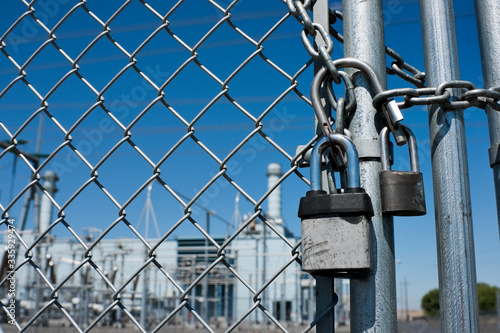 Gas Power Plant Behind Fence and Locked Gate