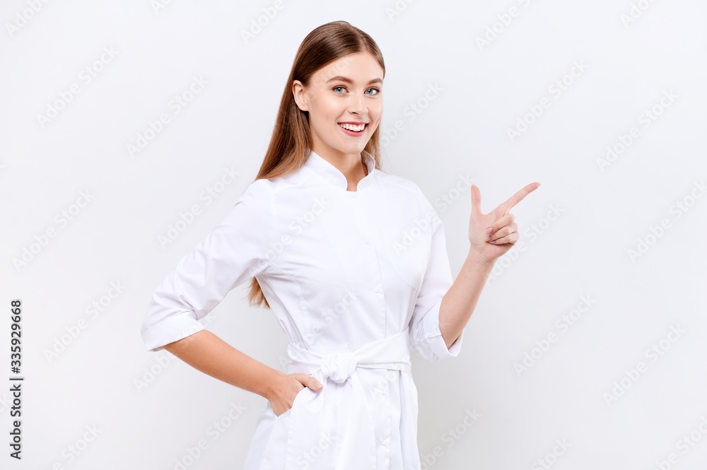 Young nurse looking at the camera and showing something on white isolated background. Corona Virus Pandemic concept Young nurse looking at the camera and showing something on white isolated background. Corona Virus Pandemic concept