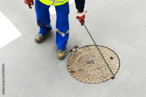 sewerage truck service and utility workers for cleaning sewer pipes in city street
