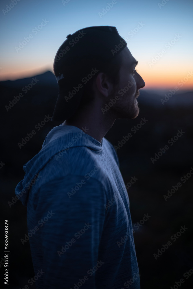 silhouette of man looking at sunset