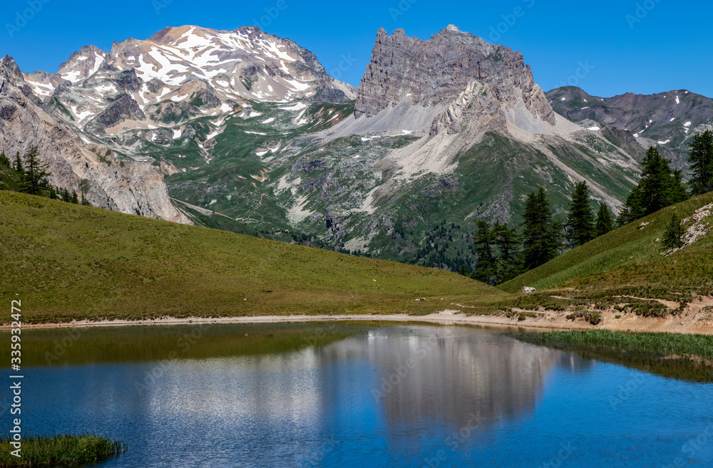 Mont Thabor and Le Grand Seru  are reflected in the Lake Chavillon on Etroite Valley in Hautes-Alpes, France.