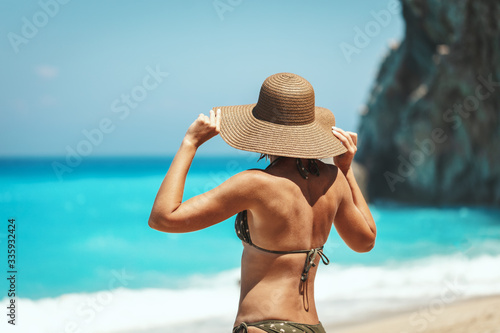 Rear View Of A Woman On Beach Against Sky