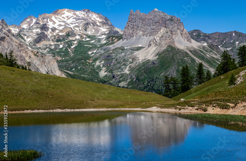 Mont Thabor and Le Grand Seru  are reflected in the Lake Chavillon on Etroite Valley in Hautes-Alpes, France. © Provisualstock.com