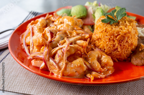 A view of a plate of shrimp Diablo, in a restaurant or kitchen setting. © DAVID