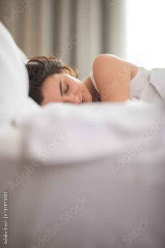 Quadro su tela Beautiful young woman sleeping on bed at bedroom