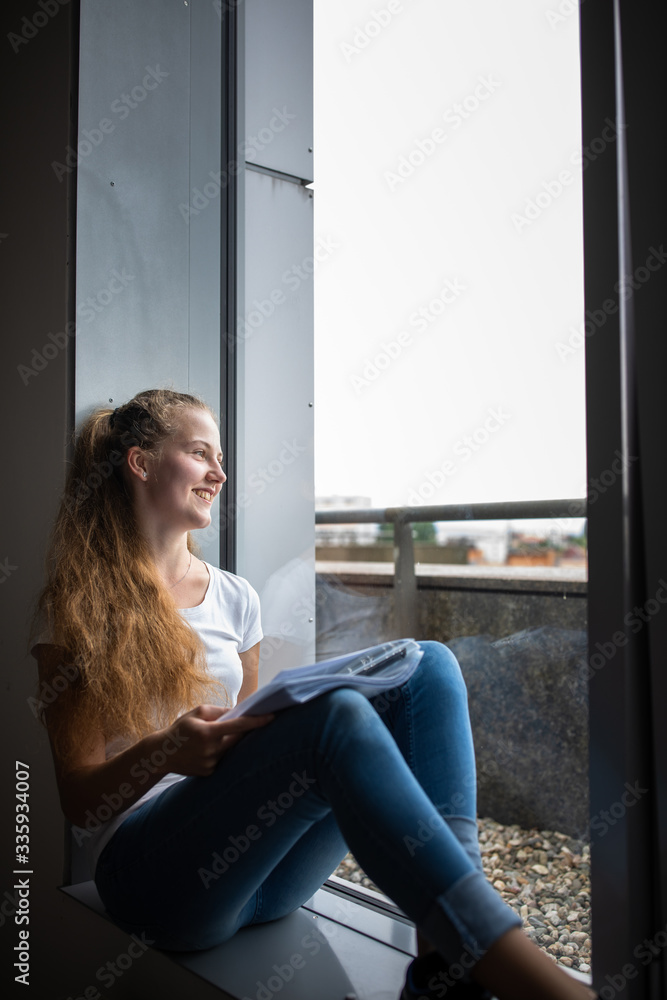 Cute female university/highschool student with books in library Cute female university/highschool student with books in library