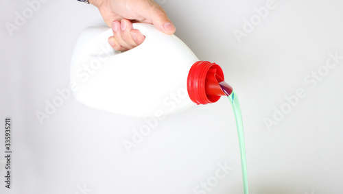 bottle of liquid detergent in hand