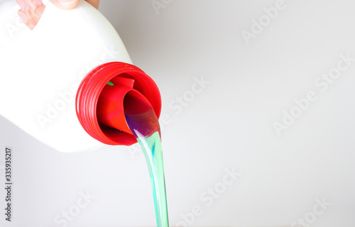 bottle of liquid detergent in hand