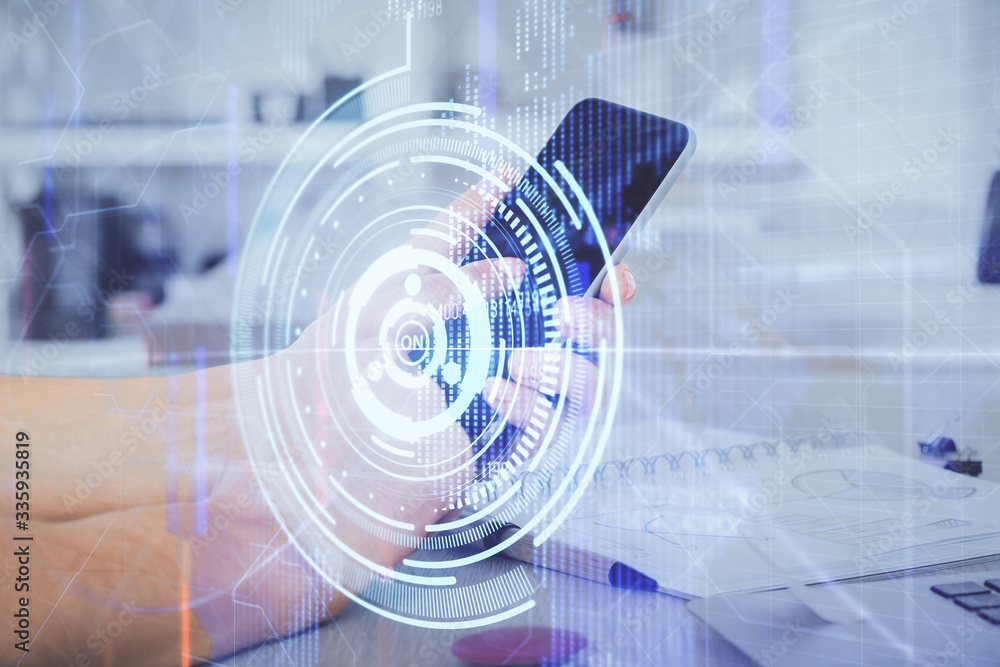 Double exposure of man's hand holding and using a digital device and data theme hologram drawing. Technology concept. Double exposure of man's hand holding and using a digital device and data theme hologram drawing. Technology concept.