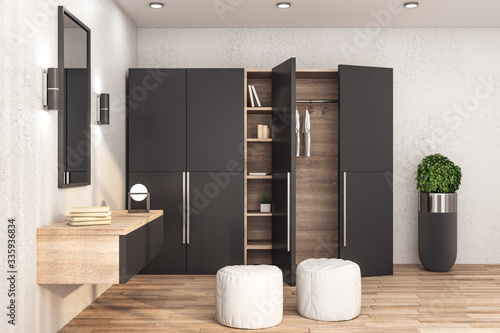 Modern wardrobe with clothes in stylish interior photo
