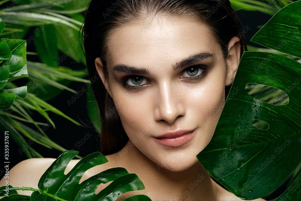 Beautiful woman naked shoulders cosmetics green leaves luxury model Beautiful woman naked shoulders cosmetics green leaves luxury model