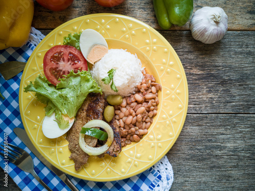 Traditional Brazilian food dish. Beans, rice, meat and salad.
