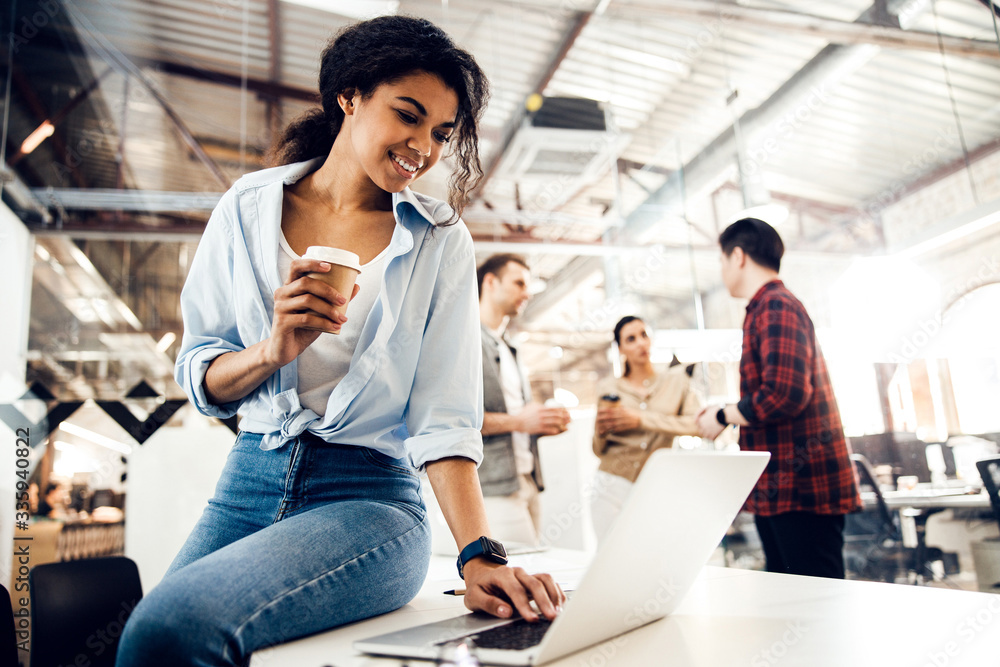 Charming young lady using modern notebook in office Charming young lady using modern notebook in office