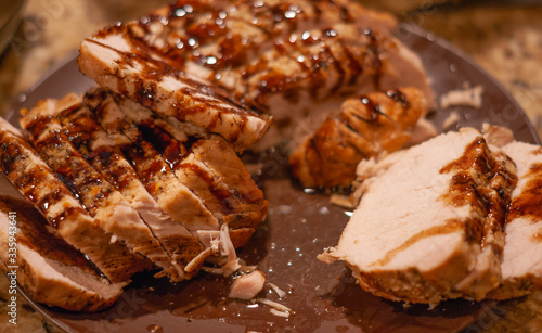 Close up of a plate of home-made pork loin with sauce with selective focus
