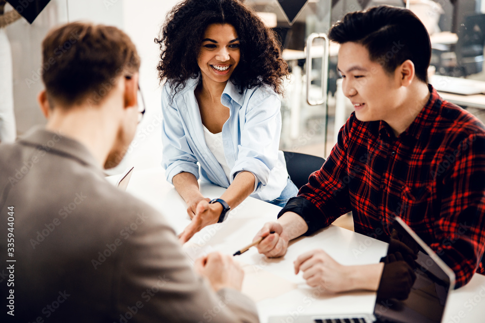 Joyful business colleagues making deal in office Joyful business colleagues making deal in office
