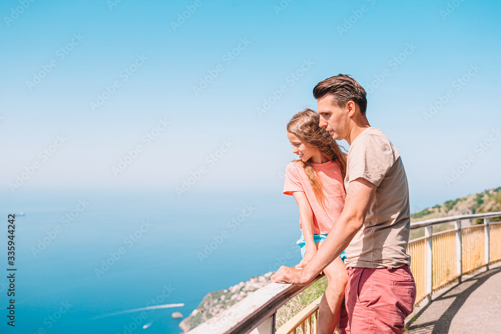 Family of dad and kid on summer vacation on the background of Amalfi Coast, Italy