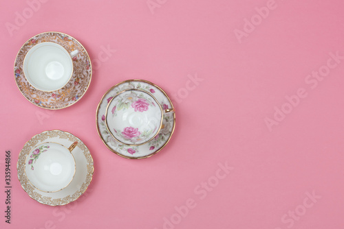Pretty vintage china teacups on a pale pink background
