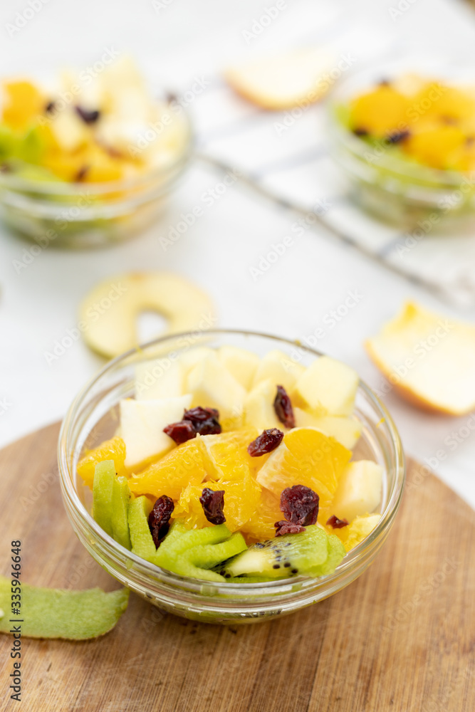 Fruit salad with kiwi orange and apple in the bowl