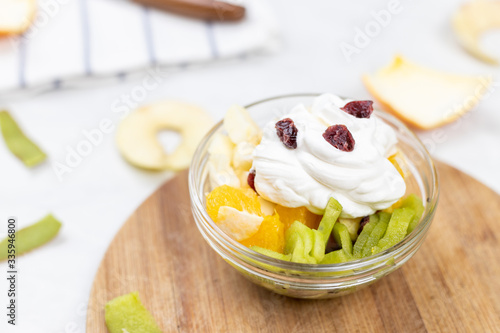 Fruit salad whipped cream flat lay white marble table