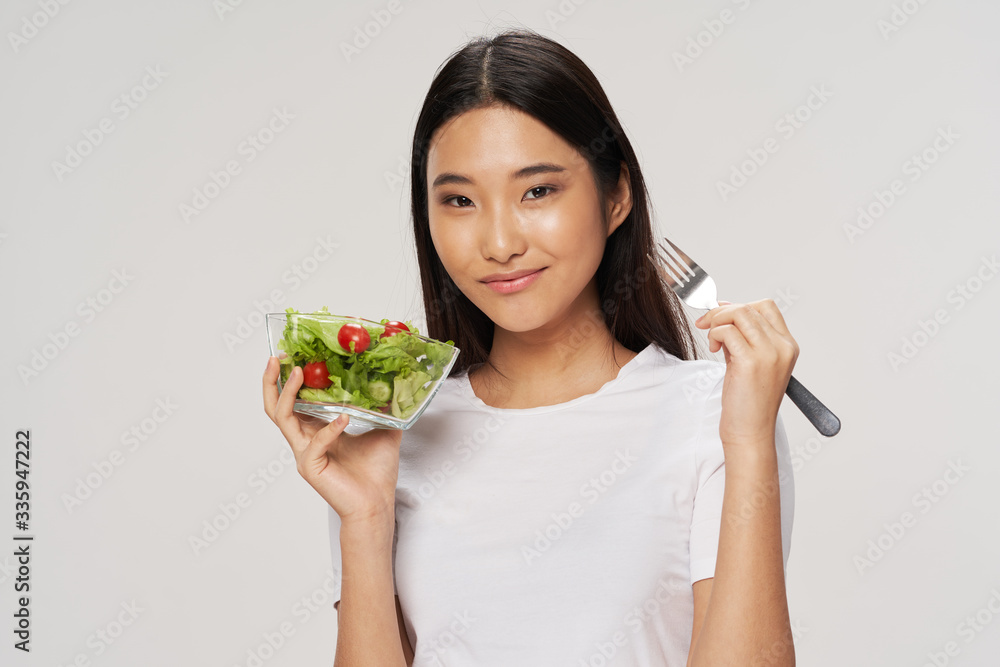 young woman eating salad young woman eating salad