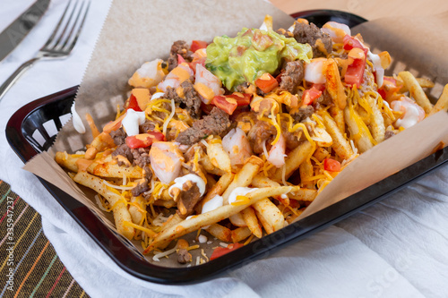 Fotografia A view of a basket of carne asada fries, in a restaurant or kitchen setting