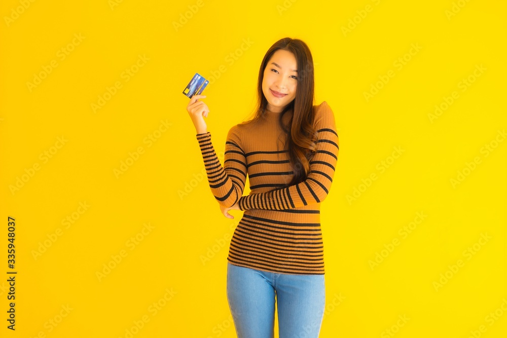 Portrait beautiful young asian woman use smart mobile phone or cellphone with credit card for online shopping Portrait beautiful young asian woman use smart mobile phone or cellphone with credit card for online shopping