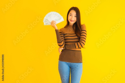 Portrait beautiful young asian woman happy smile and rich with a lot of cash in her hand