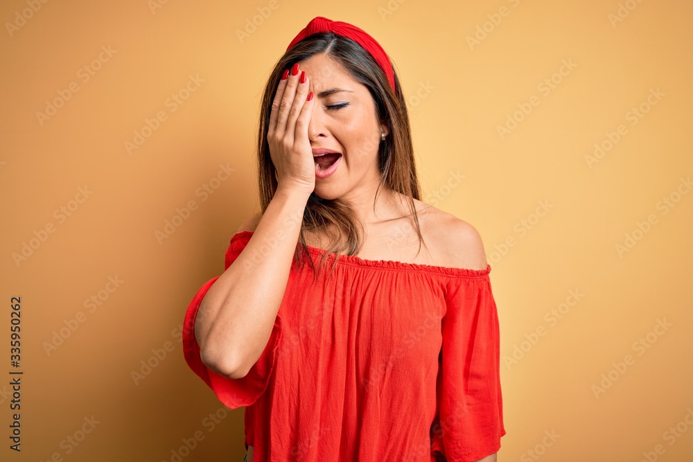 Young beautiful woman colorful summer style over yellow isolated background Yawning tired covering half face, eye and mouth with hand. Face hurts in pain. Young beautiful woman colorful summer style over yellow isolated background Yawning tired covering half face, eye and mouth with hand. Face hurts in pain.